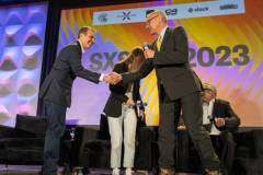 AUSTIN, TEXAS - MARCH 11: Eric O'Neill (L) shakes hands with Robert Downey Jr. onstage during the 'Online Crime: An American Crisis' SXSW panel on March 11, 2023 in Austin, Texas. (Photo by Mat Hayward/Getty Images for Aura )