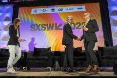 AUSTIN, TEXAS - MARCH 11: (L-R) Maria Konnikova, Hari Ravichandran, and Robert Downey Jr. speak onstage during the 'Online Crime: An American Crisis' SXSW panel on March 11, 2023 in Austin, Texas. (Photo by Mat Hayward/Getty Images for Aura )