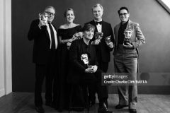 LONDON, ENGLAND - FEBRUARY 18:  (L-R) Charles Roven, Emma Thomas, Cillian Murphy, Christopher Nolan and Robert Downey Jr. are photographed backstage with their awards for the film Oppenheimer at the 2024 EE BAFTA Film Awards, held at The Royal Festival Hall on February 18, 2023 in London, England. (Photo by Charlie Clift/BAFTA/Contour by Getty Images)