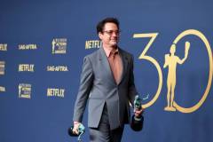 LOS ANGELES, CALIFORNIA - FEBRUARY 24: Robert Downey Jr., winner of the Outstanding Performance by a Male Actor in a Supporting Role award and the Outstanding Performance by a Cast in a Motion Picture award for 'Oppenheimer' poses in the press room during the 30th Annual Screen Actors Guild Awards at Shrine Auditorium and Expo Hall on February 24, 2024 in Los Angeles, California. (Photo by Amy Sussman/WireImage)