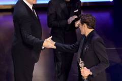 HOLLYWOOD, CALIFORNIA - MARCH 10: (L-R) Tim Robbins and Sam Rockwell present the Best Actor in a Supporting Role award for "Oppenheimer" to Robert Downey Jr.onstage during the 96th Annual Academy Awards at Dolby Theatre on March 10, 2024 in Hollywood, California. (Photo by Kevin Winter/Getty Images)