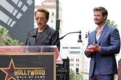 HOLLYWOOD, CALIFORNIA - MAY 23: (L-R) Robert Downey Jr. and Chris Hemsworth speak during the Hollywood Walk of Fame Star Ceremony honoring Chris Hemsworth on May 23, 2024 in Hollywood, California. (Photo by Kevin Winter/Getty Images)