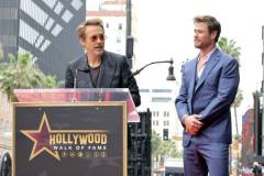 HOLLYWOOD, CALIFORNIA - MAY 23: (L-R) Robert Downey Jr. and Chris Hemsworth speak during the Hollywood Walk of Fame Star Ceremony honoring Chris Hemsworth on May 23, 2024 in Hollywood, California. (Photo by Kevin Winter/Getty Images)
