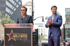 HOLLYWOOD, CALIFORNIA - MAY 23: (L-R) Robert Downey Jr. and Chris Hemsworth speak during the Hollywood Walk of Fame Star Ceremony honoring Chris Hemsworth on May 23, 2024 in Hollywood, California. (Photo by Kevin Winter/Getty Images)