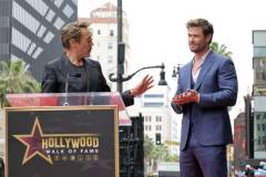 HOLLYWOOD, CALIFORNIA - MAY 23: (L-R) Robert Downey Jr. and Chris Hemsworth speak during the Hollywood Walk of Fame Star Ceremony honoring Chris Hemsworth on May 23, 2024 in Hollywood, California. (Photo by Kevin Winter/Getty Images)