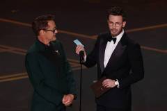 Hollywood, CA - March 15, 2026: Robert Downey Jr. and Chris Evans present the Oscars for Screenwriting during the 98th Annual Academy Awards held by the Academy of Motion Picture Arts and Sciences at the Dolby Theatre in Hollywood, CA, Sunday, March 15, 2026. (Robert Gauthier / Los Angeles Times via Getty Images)