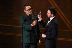 HOLLYWOOD, CALIFORNIA - MARCH 15: (L-R) Robert Downey Jr. and Chris Evans speak onstage during the 98th Oscars at Dolby Theatre on March 15, 2026 in Hollywood, California. (Photo by Kevin Winter/Getty Images)