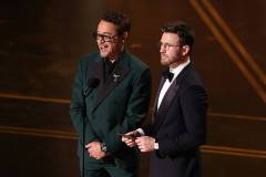HOLLYWOOD, CALIFORNIA - MARCH 15: (L-R) Robert Downey Jr. and Chris Evans speak onstage during the 98th Oscars at Dolby Theatre on March 15, 2026 in Hollywood, California. (Photo by Kevin Winter/Getty Images)