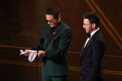 HOLLYWOOD, CALIFORNIA - MARCH 15: (L-R) Robert Downey Jr. and Chris Evans speak onstage during the 98th Oscars at Dolby Theatre on March 15, 2026 in Hollywood, California. (Photo by Kevin Winter/Getty Images)