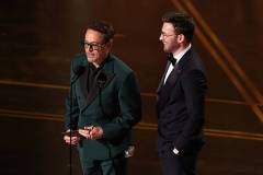 HOLLYWOOD, CALIFORNIA - MARCH 15: (L-R) Robert Downey Jr. and Chris Evans speak onstage during the 98th Oscars at Dolby Theatre on March 15, 2026 in Hollywood, California. (Photo by Kevin Winter/Getty Images)