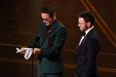 HOLLYWOOD, CALIFORNIA - MARCH 15: (L-R) Robert Downey Jr. and Chris Evans speak onstage during the 98th Oscars at Dolby Theatre on March 15, 2026 in Hollywood, California. (Photo by Kevin Winter/Getty Images)