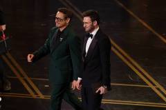 HOLLYWOOD, CALIFORNIA - MARCH 15: (L-R) Robert Downey Jr. and Chris Evans speak onstage during the 98th Oscars at Dolby Theatre on March 15, 2026 in Hollywood, California. (Photo by Kevin Winter/Getty Images)