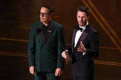HOLLYWOOD, CALIFORNIA - MARCH 15: (L-R) Robert Downey Jr. and Chris Evans speak onstage during the 98th Oscars at Dolby Theatre on March 15, 2026 in Hollywood, California. (Photo by Kevin Winter/Getty Images)