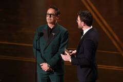 HOLLYWOOD, CALIFORNIA - MARCH 15: (L-R) Robert Downey Jr. and Chris Evans speak onstage during the 98th Oscars at Dolby Theatre on March 15, 2026 in Hollywood, California. (Photo by Kevin Winter/Getty Images)
