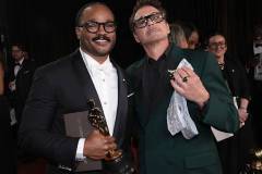 HOLLYWOOD, CALIFORNIA - MARCH 15: In this handout photo provided by The Academy, Ryan Coogler with Writing (Original Screenplay) award for "Sinners" and Robert Downey Jr. pose backstage during the 98th Oscars at Dolby Theatre on March 15, 2026 in Hollywood, California. (Photo by Al Seib / The Academy via Getty Images)