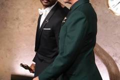 HOLLYWOOD, CALIFORNIA - MARCH 15: In this handout photo provided by The Academy, presenter Robert Downey Jr. (R) walk off stage as Ryan Coogler carries the Writing (Original Screenplay) award for "Sinners" during the 98th Oscars at Dolby Theatre on March 15, 2026 in Hollywood, California. (Photo by Al Seib / The Academy via Getty Images)